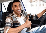 Man smiles in car