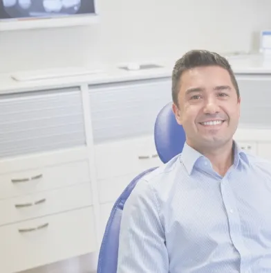 Smiling man sitting in dental chair