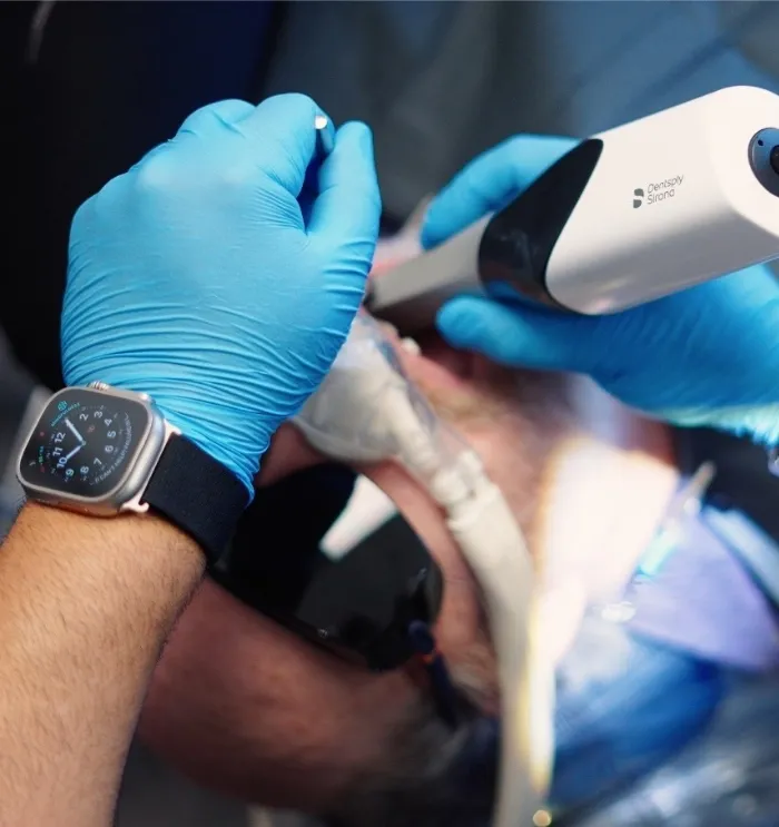 Dentist capturing digital impressions of a patients teeth