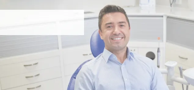 Smiling man sitting in dental chair